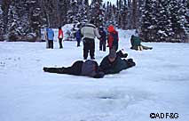 Amy Williams showing Nelson Deschene how to watch the action under the ice