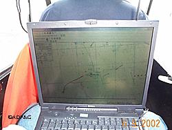 Biologists keep an eye on the computer as well as the landscape during aerial bear surveys