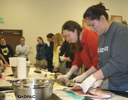 A group of BOW participants learn to filet