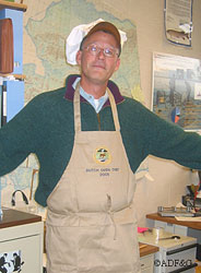 Charlie Swanton shows off the trophy apron won in the 2005 Fairbanks ADFampG Dutch Oven CookOff for this salmon recipe