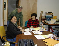 Division researchers Ted Krieg and Molly Chythlook of Dillingham train Togiak resident Clara Ann Martin to administer big game harvest surveys  Photo by Hans Nicholson