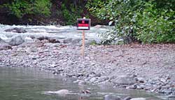 Under Alaska law ownership of uplands adjacent to navigable or public water does not grant an exclusive right to use the water or to control public use of the water even if the title includes the submerged land