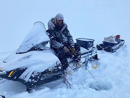 ADFampG fisheries biologist Matt Albert fishes for lake trout in Tangle Lakes in April 2022 for a radio telemetry project ADFampG photo
