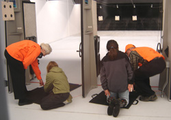 Volunteer hunter education instructors working with youth at the Juneau indoor range