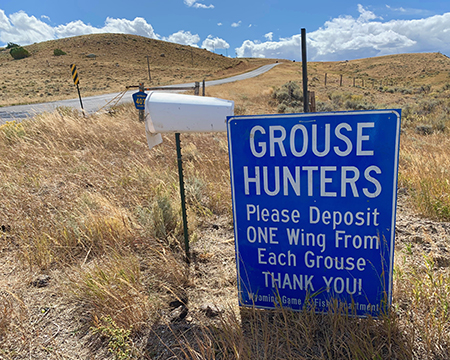 A sign notifies hunters in Wyoming about a wing collection program Alaska bird hunters also help biologists with a similar program