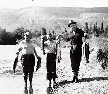 Three people on shoreline holding fish Cooper Landing Alaska 1940 Alaska State Library Doyle C Tripp photograph collection
