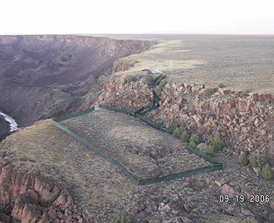 Returning Bighorn Sheep to the Rio Grande Gorge Taos Pueblo New Mexico This bighorn population is now the largest in New Mexico An aerial view of completed pen and alleyway where sheep moved from the truck on the rim to the pen The open release gate can be seen near the center of this photo