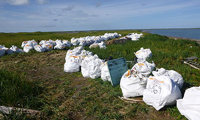 Super sacks of bagged marine debris on Tugidak Island awaiting haul out Photo courtesy Island Trails Network