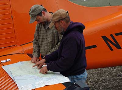 Caribou biologist Jim Dau and biologist and pilot Tom Seaton plan a flight with the department39s beaver to survey the Western Arctic Caribou Herd Photo by Geoff Carroll