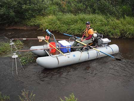 Ryan Snow using cataraft mounted electrofisher to inventory fish in a remote Alaskan stream photo by James Bales