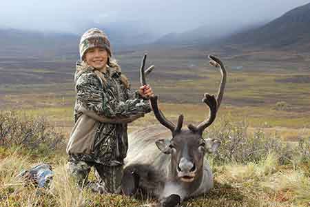 A young hunter continues a family tradition Jordan Strausbaugh 10 with a caribou she harvested in GMU 13 on a family hunting trip She helped butcher and process the caribou