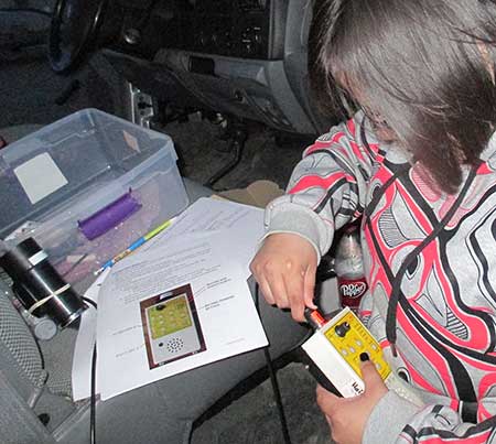 A volunteer citizen scientist prepares for a driving survey She39s plugging the microphone into the bat detector