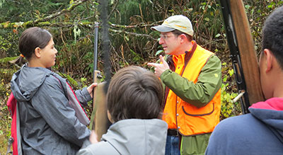 Volunteer hunter ed instructor Jesse Keihl teaches students handling nonfunctioning firearms  to safely board and disembark from a skiff or dinghy with a firearm Jeff Jemison photo