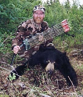 Bowhunter Tom Payer with a black bear taken over bait in Interior Alaska