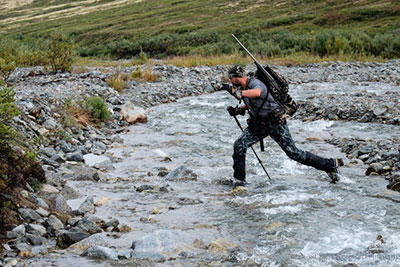 Gabe Bleau crosses Carpenter Creek on a sheep hunt Photograph courtesy Ben Reynolds