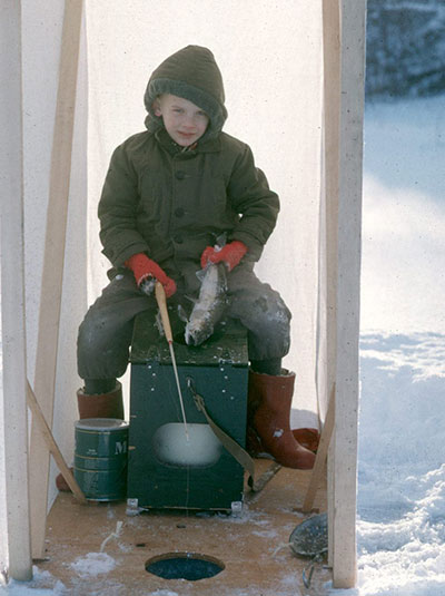 A nearly sixyearold Clark Fair shows off a landlocked silver salmon he caught while icefishing on Scout Lake just north of Soldotna