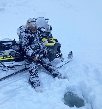 ADFampG fisheries biologist Corey Schwanke fishes for lake trout in Tangles Lakes in April 2022 for a radio telemetry project ADFampG photo