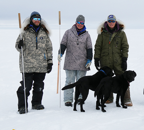 Ringed seal researchers L to R Justin Crawford Anna Bryan and Lori Quakenbush Dogs L to R Stout and Indigo Photo by Craig Perham